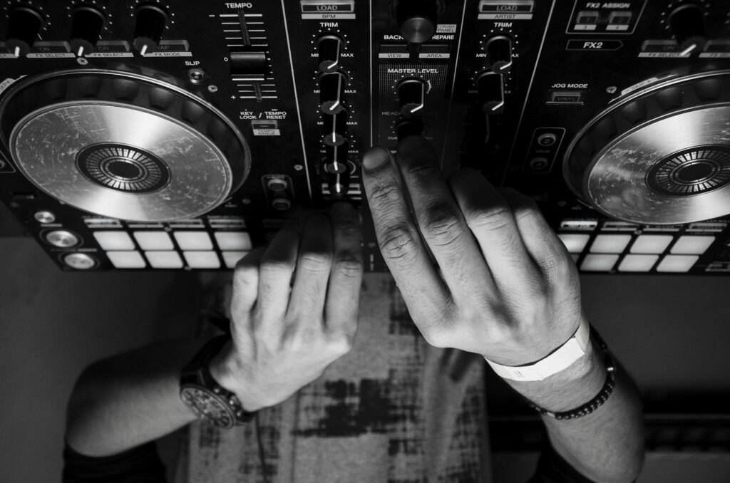 Grayscale Photography of Person Using Dj Controller